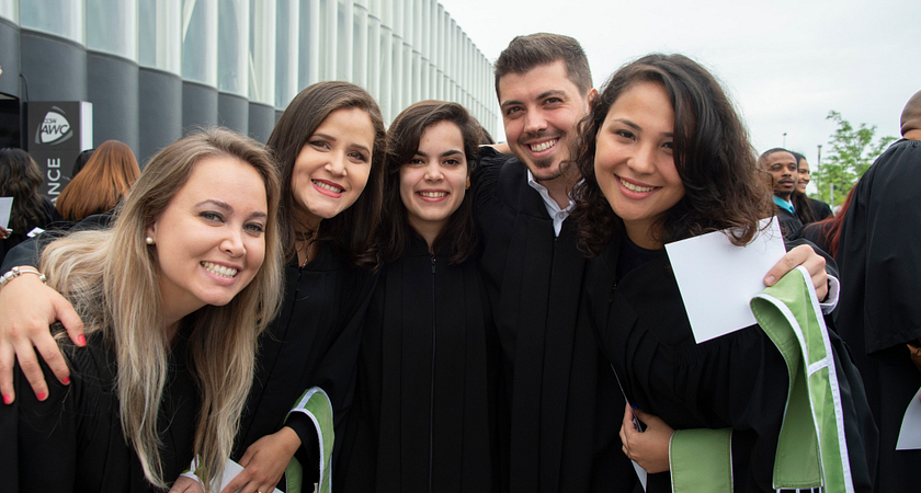 happy centennial college graduates at their convocation ceremony posing for a group photo